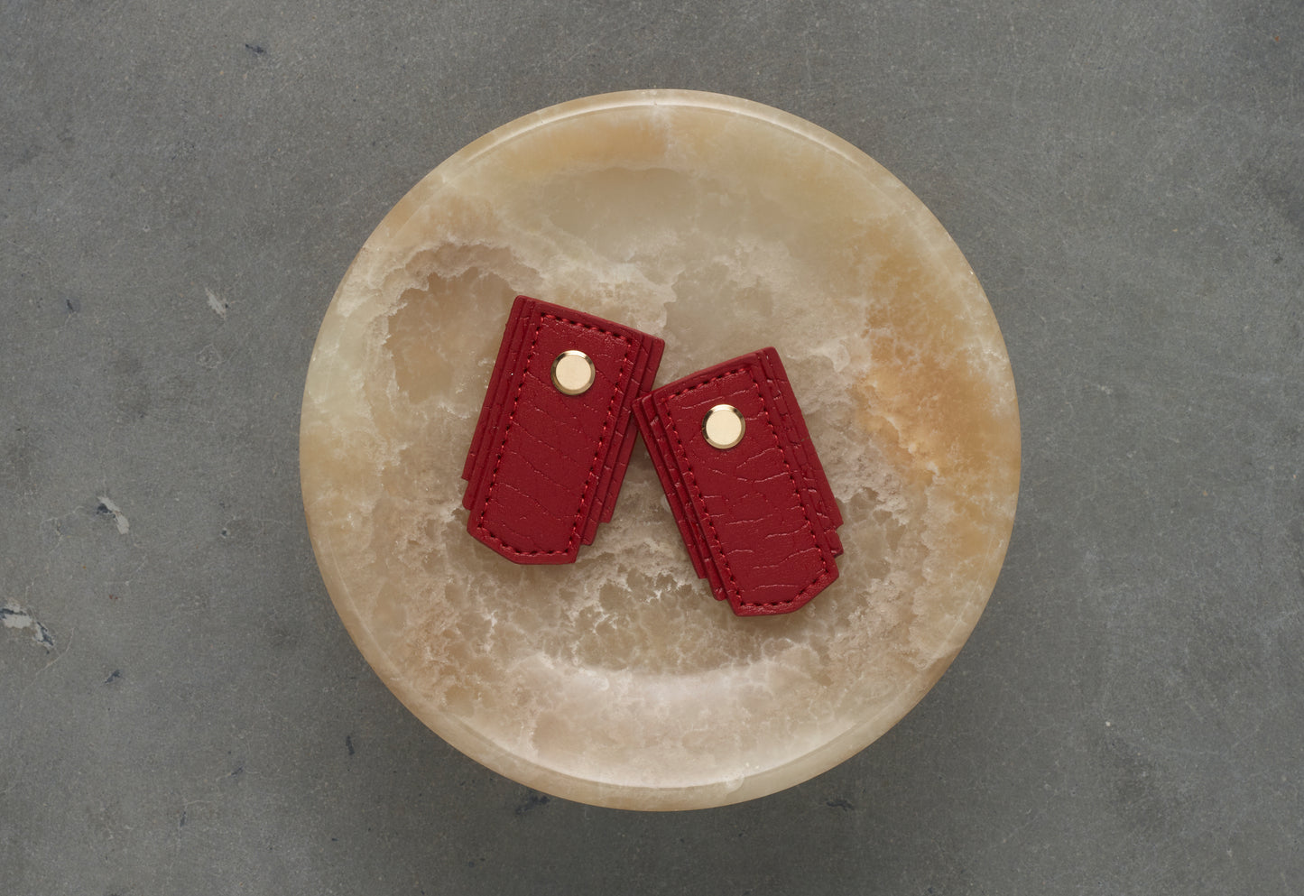 Red leather pull from Sagitine, featuring a sleek design and high-quality craftsmanship