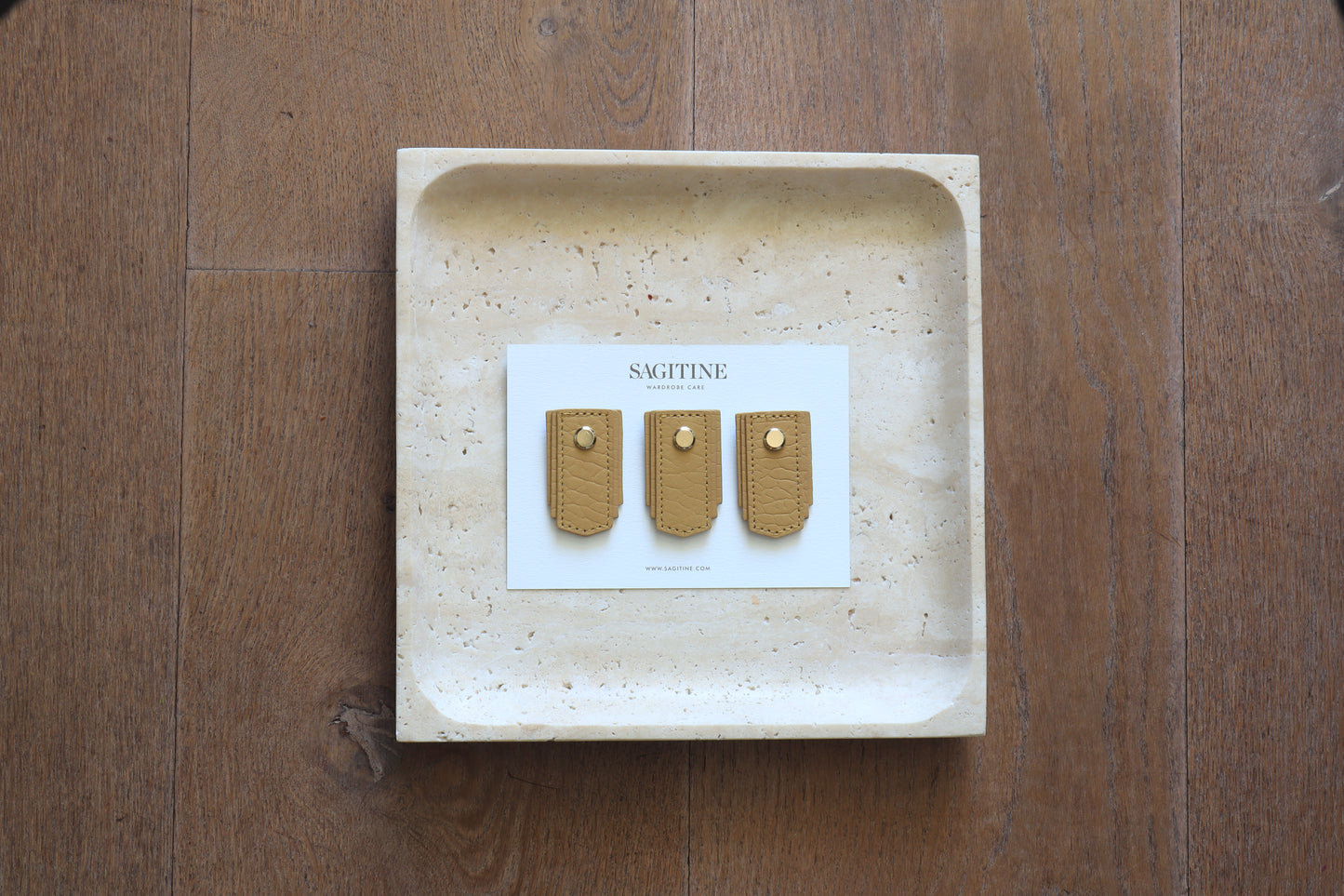 Biscuit leather pull handle by Sagitine, featuring a smooth finish and modern design.