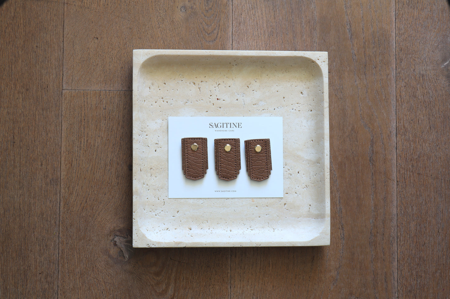 Rose gold leather pull handle by Sagitine with a sleek and modern design.