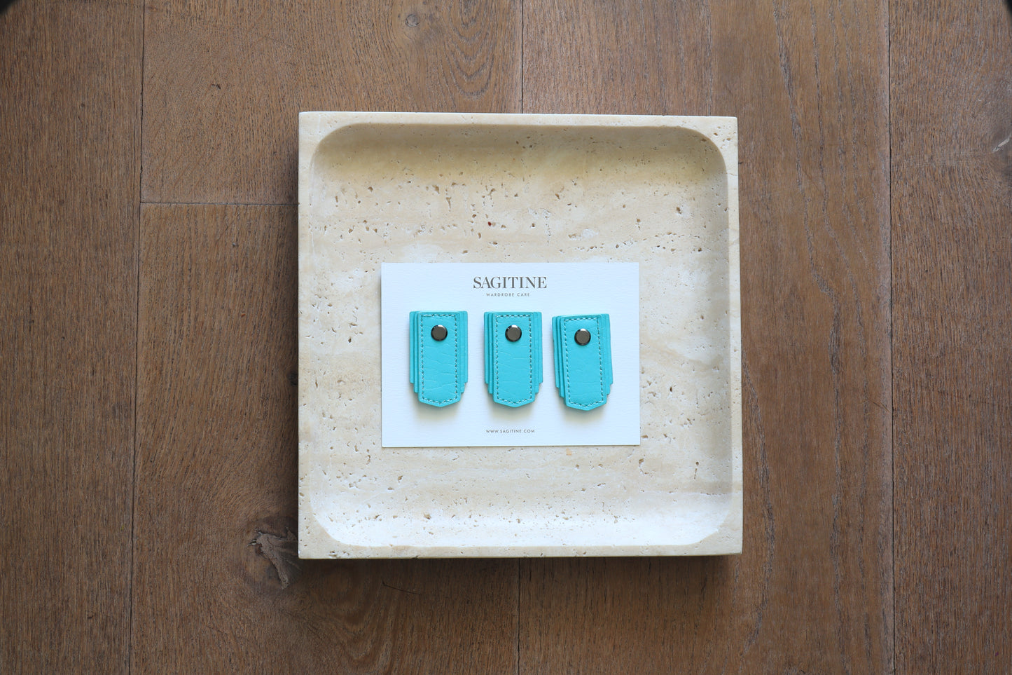 Seafoam leather pull handle by Sagitine, featuring a soft texture and modern design.