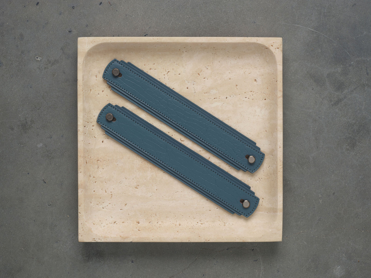 Blue leather handle by Sagitine with a sleek design for easy gripping