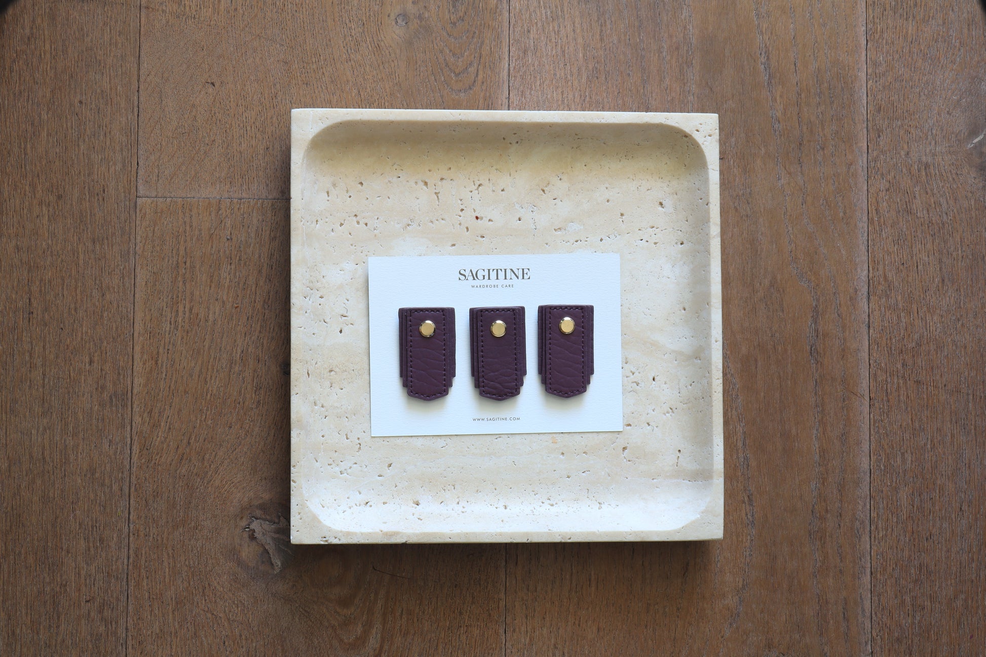 Plum leather pull handle by Sagitine, featuring a sleek and simple design.